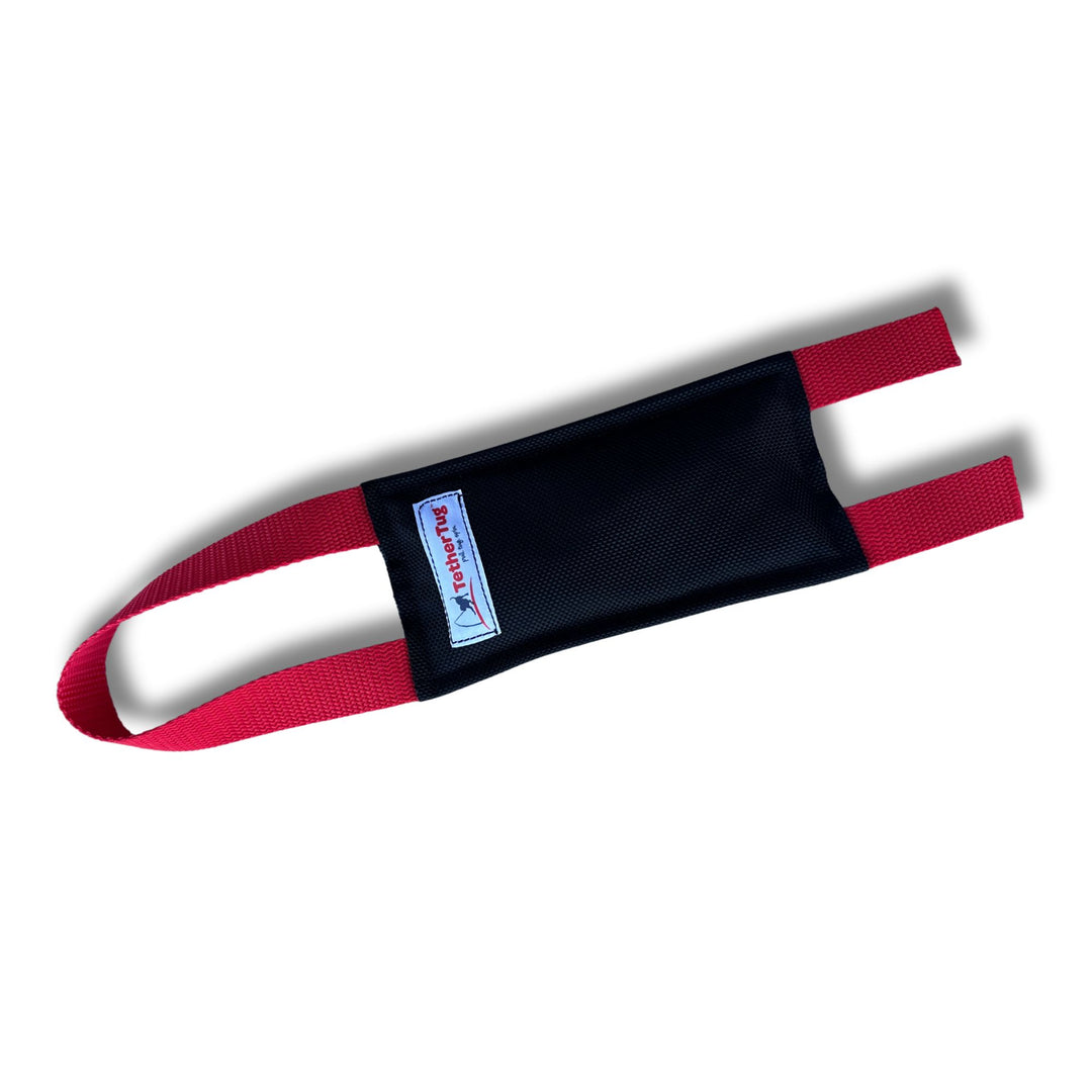 Black tug toy with red handles and a 'TechTug' label.